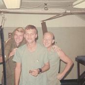 In the dispensary examination room. Left to right: Corpsmen John West, Gary, and Pete Sheey. My dad is eating a browine from a care package. November 1968. Photo courtesy of George Williams.
